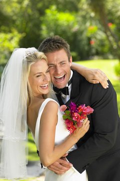 BananaStock/BananaStock/Getty Images You could end up on the hook for your wife's debt after your wedding day.
