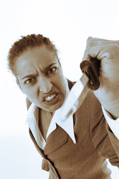 BananaStock/BananaStock/Getty Images Recognize, then overcome, office bullying.