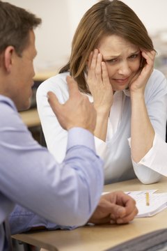 BananaStock/BananaStock/Getty Images Keep your cool when your boss bullies you.