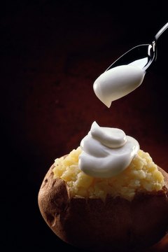 Jupiterimages/Comstock/Getty Images Top your baked potato with Greek yogurt.