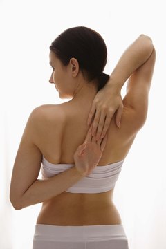Jupiterimages/Goodshoot/Getty Images Avoid sore back muscles with stretching.