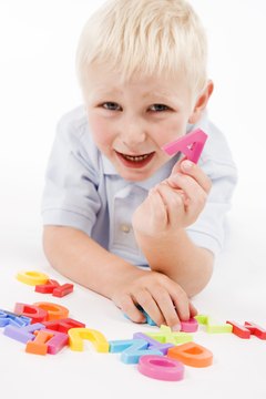 Young children can use magnetic letters to create words.