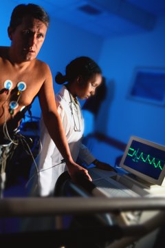 During a stress test, a patient walks on a treadmill while a technician monitors changes in his heart.