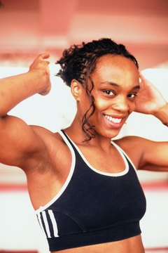 John Foxx/Stockbyte/Getty Images Rip your triceps with the help of a tricep bar.
