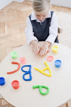 Kids can reinforce letters and numbers while using modeling clay, too.