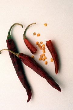 Jupiterimages/Photos.com/Getty Images Hot peppers can be found fresh or dried.
