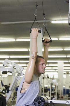 Jupiterimages/Comstock/Getty Images Work your chest and arms with cable routines to build strength.