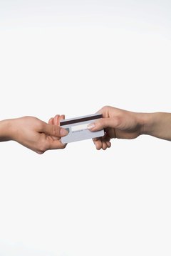 Hands holding credit card