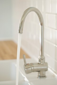 Jupiterimages/Comstock/Getty Images Installing low-flow water faucets is one way to conserve water.