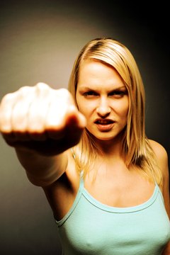 Stockbyte/Stockbyte/Getty Images Racial slurs at work are nonphysical punches that violate Civil Rights laws.