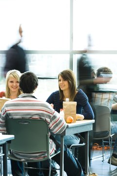 Multiple high school lunch periods may mean missing friends dining at different times.