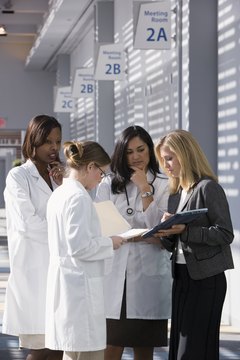 Comstock Images/Comstock/Getty Images Medical school students may qualify for fully paid Navy scholarships.