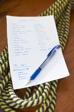 Packing list for camping trip with pen and rope
