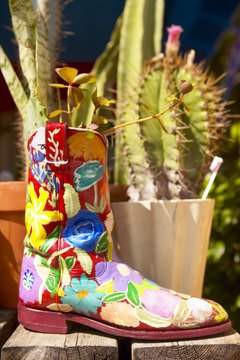 Jupiterimages/Photos.com/Getty Images Give costly new planters the boot by reusing offbeat materials.