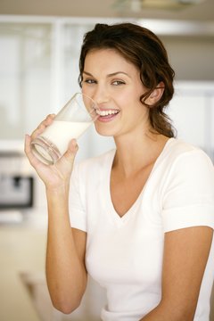Goodshoot/Goodshoot/Getty Images While soda just delivers carbs, milk provides carbs, proteins, vitamins and minerals.