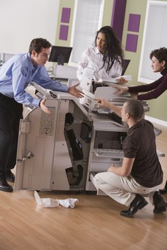 Comstock Images/Comstock/Getty Images A noisy malfunctioning photocopier frustrates employees.