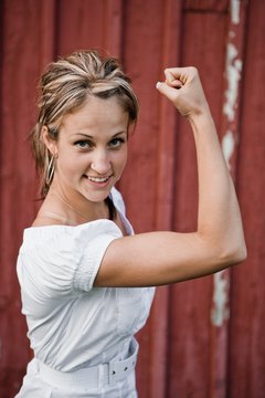 Jupiterimages/Photos.com/Getty Images Lose the wobbly underarms with cardio and dumbbell exercises.