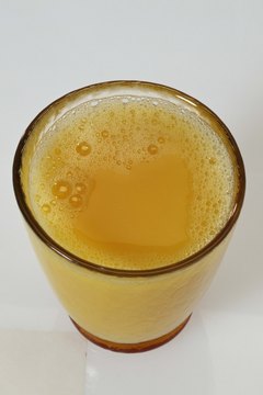 Jupiterimages/Comstock/Getty Images 100 percent juice contains potassium and vitamin C.
