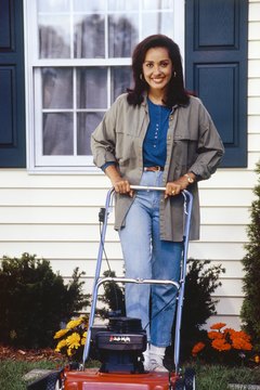 Jupiterimages/Photos.com/Getty Images Mowing the lawn provides a moderate cardio workout.
