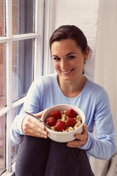 Creatas/Creatas/Getty Images Fruits, whole grains, low-fat milk and other healthy foods can help reduce bloating.