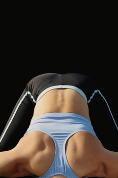 Ryan McVay/Lifesize/Getty Images Take a deep breath, exhale slowly and stretch your lower back.
