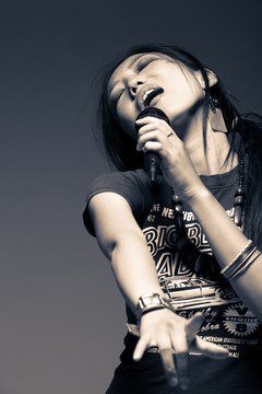 Jupiterimages/Photos.com/Getty Images Professional singers can face long hours, lengthy rehearsals and uncertain work opportunities.