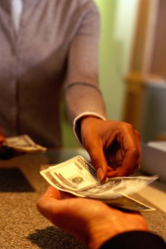 Ryan McVay/Photodisc/Getty Images Several services can help you cash checks and shop safely without a bank account or debit card.