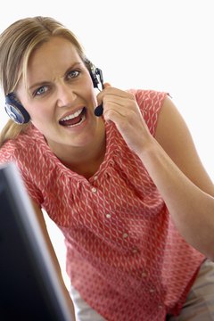 Jupiterimages/Goodshoot/Getty Images Swearing at work can often be grounds for termination.