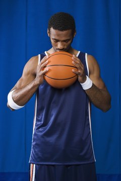 Jupiterimages/Pixland/Getty Images Pro basketball players practice their game daily.