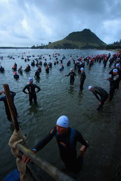 Phil Walter/Getty Images Sport/Getty Images Swimmers get ready to take the plunge at a half Ironman in New Zealand.