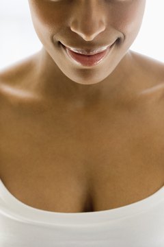 Jupiterimages/Creatas/Getty Images Strength-training moves for the chest can tighten muscles beneath your breasts.