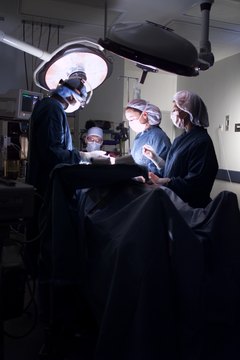 Photodisc/Photodisc/Getty Images Operating rooms need teams of medical professionals, including doctors, nurses and technicians.