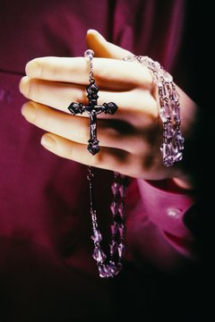 A priest often leads the rosary at a Catholic wake.