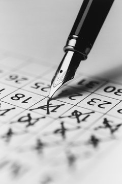Pen Marking the Days on a Calendar