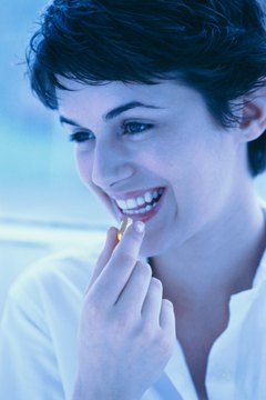 George Doyle/Stockbyte/Getty Images Vitamins can help to support natural thyroid function.
