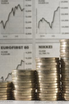 Euro Currency: Stacked coins, financial graphs in background