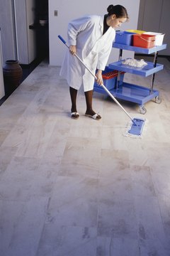 Woman with maid cart cleaning floor
