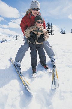 Digital Vision./Photodisc/Getty Images Beginners need a loose DIN setting so their skis come off easily.