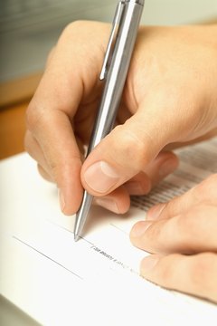 Person signing contract, close-up, selective focus