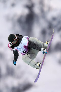 Richard Heathcote/Getty Images Sport/Getty Images A competitor at the 2013 women's World Cup snowboard competition bends into the jump.