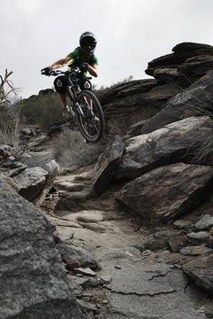 Thomas Northcut/Digital Vision/Getty Images Mountain bikes vary in frame styles, materials, wheel size, clearance and other aspects.