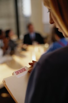 Ryan McVay/Photodisc/Getty Images Reviewing an employee's personnel file is regulated by company policy.