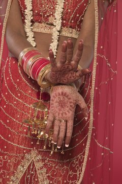 Muslim brides in the Asian subcontinent often have henna tattoos painted on their hands and feet for the wedding ceremony.