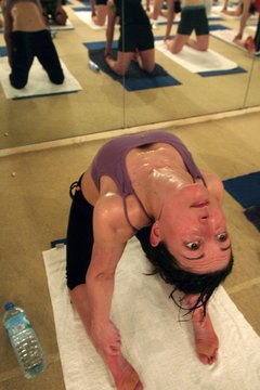Matt Cardy/Getty Images News/Getty Images Prepare to sweat in a Bikram yoga class.