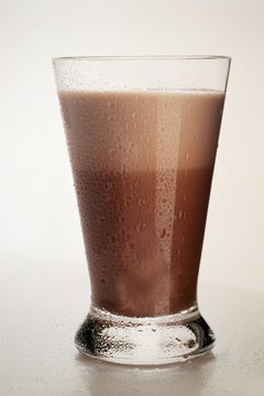 Eising/Photodisc/Getty Images A glass of chocolate milk is ideal after different types of strength training.