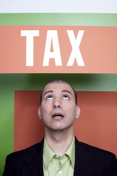 Man under a tax sign