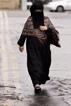 Some women wear a niqab, a black full-body cover that hides the face.