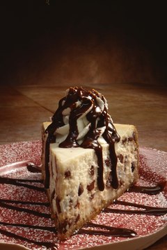 Jupiterimages/Comstock/Getty Images Limit your consumption of foods, such as cheesecake, that are high in saturated fat and cholesterol.