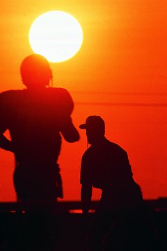 Stockbyte/Stockbyte/Getty Images The daily life of a football coach starts early and ends late, especially during the season.