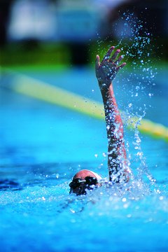 Digital Vision./Digital Vision/Getty Images There are plenty of weightlifting exercises that will build muscles in the shoulders, legs and core for backstrokers.